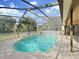 Relaxing screened-in pool with a sparkling water, and nice patio area at 8124 Golf Club Ct, Hudson, FL 34667