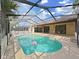 A beautifully screened-in pool with an open patio and multiple access points at 8124 Golf Club Ct, Hudson, FL 34667