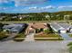 Aerial view of a single-story home showcasing a two-car garage, landscaping, and a well-kept lawn at 8127 Tarsier Ave, New Port Richey, FL 34653