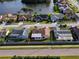 Aerial view of homes close to lake, mature trees and landscaping at 8127 Tarsier Ave, New Port Richey, FL 34653