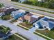 Aerial view of neighborhood homes and proximity to busy roadway and green spaces at 8127 Tarsier Ave, New Port Richey, FL 34653