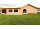 Exterior house and backyard view with green grass and blue skies at 8127 Tarsier Ave, New Port Richey, FL 34653