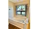 Bright bathroom with a garden tub and decorative window at 8127 Tarsier Ave, New Port Richey, FL 34653