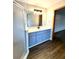 Bathroom featuring blue cabinets, new countertop, modern fixtures, and walk-in shower at 8127 Tarsier Ave, New Port Richey, FL 34653