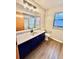 Bathroom featuring blue vanity and shower/tub combo at 8127 Tarsier Ave, New Port Richey, FL 34653