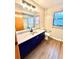 Bathroom featuring blue vanity and shower/tub combo at 8127 Tarsier Ave, New Port Richey, FL 34653
