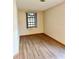 Bedroom showcasing natural light from the windows and stylish wood-look floors at 8127 Tarsier Ave, New Port Richey, FL 34653