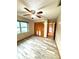 Bedroom featuring tiled flooring, closet, ceiling fan and access to the hall at 8127 Tarsier Ave, New Port Richey, FL 34653