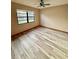 Bedroom featuring modern floors, a ceiling fan, and natural light from the window at 8127 Tarsier Ave, New Port Richey, FL 34653
