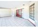 Spacious bonus room with tile flooring and a sliding door leading to the patio at 8127 Tarsier Ave, New Port Richey, FL 34653