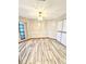 Dining room featuring light wood flooring, overhead lighting, and a window at 8127 Tarsier Ave, New Port Richey, FL 34653