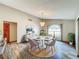 Modern dining room with chandelier, round table, and neutral color scheme at 8127 Tarsier Ave, New Port Richey, FL 34653