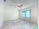 Empty room with natural lighting, neutral walls, and wood-look flooring at 8127 Tarsier Ave, New Port Richey, FL 34653