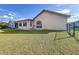 Exterior side yard with large decorative window and green lawn at 8127 Tarsier Ave, New Port Richey, FL 34653