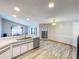 Open concept kitchen with light cabinetry, stainless steel appliances and tile floors at 8127 Tarsier Ave, New Port Richey, FL 34653