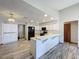 Bright kitchen with white cabinets, black appliances, and wood-look tile flooring at 8127 Tarsier Ave, New Port Richey, FL 34653