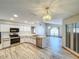 Bright kitchen featuring modern appliances, white cabinets, and stylish wood-look tile flooring at 8127 Tarsier Ave, New Port Richey, FL 34653