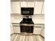 Well-equipped kitchen with stainless steel oven, microwave and white cabinets at 8127 Tarsier Ave, New Port Richey, FL 34653