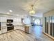 Bright kitchen featuring stainless steel appliances, tiled flooring, and modern lighting at 8127 Tarsier Ave, New Port Richey, FL 34653