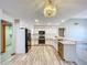 Bright kitchen featuring stainless steel appliances, tiled flooring, and modern lighting at 8127 Tarsier Ave, New Port Richey, FL 34653