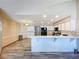 Open-concept kitchen featuring white cabinets, modern appliances, and a breakfast bar at 8127 Tarsier Ave, New Port Richey, FL 34653