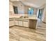 Modern kitchen featuring stainless steel appliances, white cabinets, and a breakfast bar at 8127 Tarsier Ave, New Port Richey, FL 34653