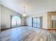 Bright living area featuring wood-look tile flooring, a vaulted ceiling, and a modern chandelier at 8127 Tarsier Ave, New Port Richey, FL 34653