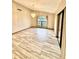 Large living room featuring wood-look tile flooring, chandelier, and large windows at 8127 Tarsier Ave, New Port Richey, FL 34653