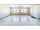 Open living room with tile flooring and abundant natural light from multiple windows at 8127 Tarsier Ave, New Port Richey, FL 34653
