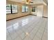 Spacious room with a tile floor, neutral walls, ample windows, and a ceiling fan at 8127 Tarsier Ave, New Port Richey, FL 34653