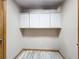 Storage room featuring mounted cabinets and updated floors at 8127 Tarsier Ave, New Port Richey, FL 34653