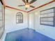 Enclosed sun room with blue flooring, and three windows providing abundant light at 8127 Tarsier Ave, New Port Richey, FL 34653