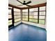 Enclosed sunroom featuring floor-to-ceiling windows and a ceiling fan at 8127 Tarsier Ave, New Port Richey, FL 34653