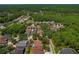 An aerial view of a home with mature trees in a neighborhood; property is circled in red at 8211 Canyon Creek Way, Tampa, FL 33647