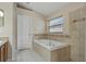 Primary bathroom featuring a large soaking tub with tile surround and a separate shower at 8211 Canyon Creek Way, Tampa, FL 33647