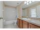 This bathroom features a vanity with wood cabinets, tile flooring and a shower and tub combo at 8211 Canyon Creek Way, Tampa, FL 33647