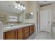 Bathroom featuring a double vanity, mirrors, and tiled floors, enhancing a spa-like feel at 8211 Canyon Creek Way, Tampa, FL 33647