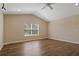 Spacious bedroom with vaulted ceiling, wood floors, and a large window at 8211 Canyon Creek Way, Tampa, FL 33647