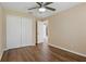 This bedroom features hardwood floors, ceiling fan and a double door closet at 8211 Canyon Creek Way, Tampa, FL 33647