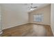 Bedroom with wood-look flooring, a ceiling fan, and natural light from a window at 8211 Canyon Creek Way, Tampa, FL 33647