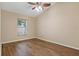 This bedroom features hardwood floors, ceiling fan, and a window that brings in natural light at 8211 Canyon Creek Way, Tampa, FL 33647
