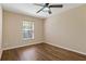 This bedroom features hardwood floors, ceiling fan, and a window that brings in natural light at 8211 Canyon Creek Way, Tampa, FL 33647