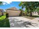 Charming one-story home with a two-car garage, manicured lawn, and lush landscaping at 8211 Canyon Creek Way, Tampa, FL 33647