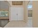 Elegant foyer with double doors, tile flooring, and views to the formal living room at 8211 Canyon Creek Way, Tampa, FL 33647
