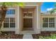 Front entry featuring double doors, a pendant light, and manicured landscaping at 8211 Canyon Creek Way, Tampa, FL 33647