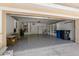 Spacious two-car garage with epoxy flooring, built-in shelving, and ample storage space at 8211 Canyon Creek Way, Tampa, FL 33647