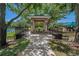 Community gazebo with a picnic table alongside a playground, tennis court, and grassy green space at 8211 Canyon Creek Way, Tampa, FL 33647