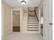 Hallway with white staircase and tile flooring, with hardwood floors in the adjacent room at 8211 Canyon Creek Way, Tampa, FL 33647