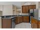 Galley kitchen featuring stainless steel dishwasher, open shelving, and abundant counter space at 8211 Canyon Creek Way, Tampa, FL 33647
