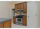 Gourmet kitchen with stainless steel range, microwave, and tiled flooring at 8211 Canyon Creek Way, Tampa, FL 33647